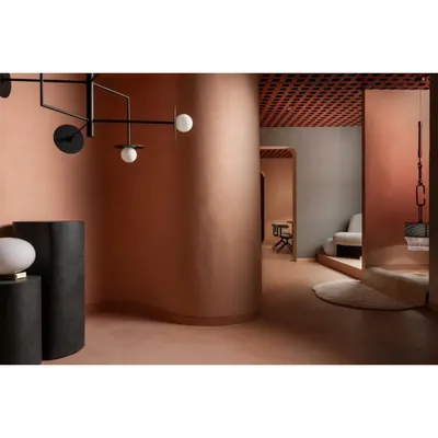 The layout flows with soft, curved walls, guiding visitors through different lighting vignettes. This design choice eliminates harsh corners and creates a more gentle, exploratory journey through the retail space.