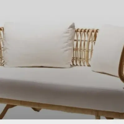 Our two-seater rattan sofa combines a modern, minimalist frame with traditional weaving techniques. It's a lightweight yet durable piece, perfect for compact living spaces, office lounges, or boutique hotel rooms, complete with comfortable, high-quality cushions.