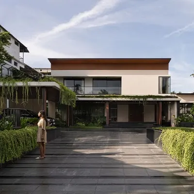 The exterior of Villa Shakthi in Cherpu, Kerala, is defined by a central pool court that anchors the entire design. The home is spread across a 2,500 sqm site, with rooms and circulation oriented to overlook this tropical oasis, creating a constant connection between the indoors and the lush landscape.