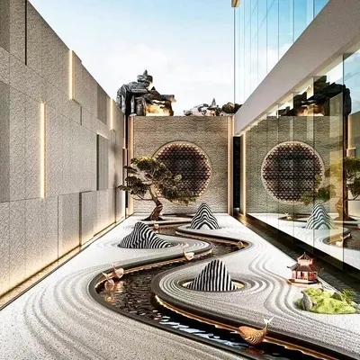 A contemporary interpretation of a Japanese Zen garden. This contemplative space uses raked white sand to symbolize water, with sculptural elements representing islands. A small, meandering water channel adds a sensory element, creating a powerful statement of tranquility and minimalist design.