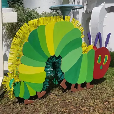 Here's a close-up of the famous Hungry Caterpillar, handcrafted from cardboard with a fun, fringed spine. This life-sized character prop was a huge hit with the kids and brought the beloved storybook to life.