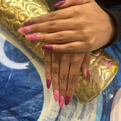 A full view of this beautiful marble nail art on long acrylic extensions. I combined solid magenta nails with accent nails featuring a hand-painted pink marble design.