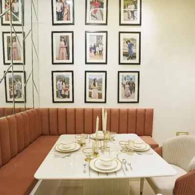 Designed for dinners, remembered for moments. This cozy dining nook features comfortable banquette seating and a gallery wall for family photos.