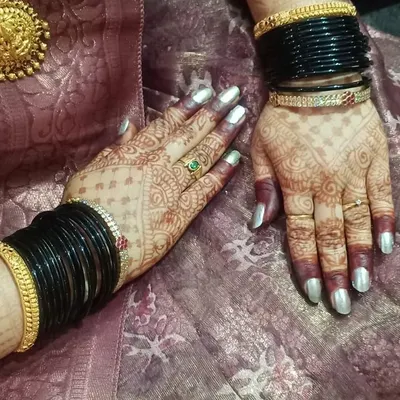 A beautiful shot of the developed henna stain, complemented by traditional black bangles. The deep color shows the quality of the organic paste I use.