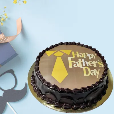 A classic chocolate cake for Father's Day, featuring a rich chocolate ganache and a printed "Happy Father's Day" message with a tie motif. It's a simple, delicious, and heartfelt way to celebrate your dad.