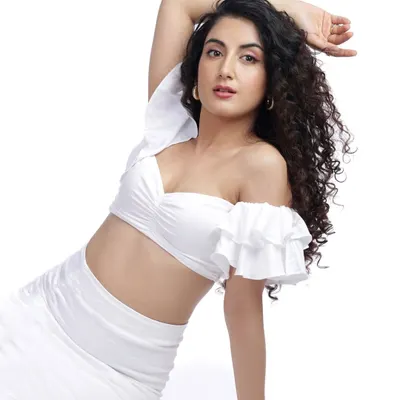 A clean, high-key studio shot in all white. This type of image is perfect for a portfolio, showcasing the model's form and features with bright, even lighting.