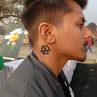 A bold geometric symbol, the Valknut, painted on the neck. This type of sharp, symbolic art is very popular and makes a strong statement.