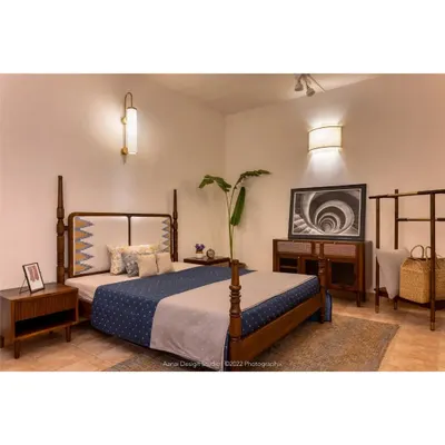 A complete bedroom setting at our studio, featuring the Maadhya bed with its distinctive headboard, the Soiree bedside table, the Sirutha console, and the Makam clothes rack. This demonstrates how we can furnish an entire bedroom with coordinated pieces.