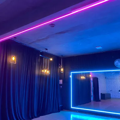 Another view of our studio space, highlighting the professional setup with mirrors and custom lighting. This is where the magic happens.