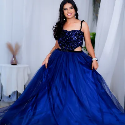 A full-length shot of a glamorous party look. I created a bold eye and styled the hair in loose waves to match the drama of this stunning sequined blue gown.