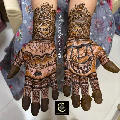 A special design for a special occasion. This baby shower mehendi features "Mom" and "Dad" on the wrists, with a baby in a cradle on one palm and other cute baby-related motifs.