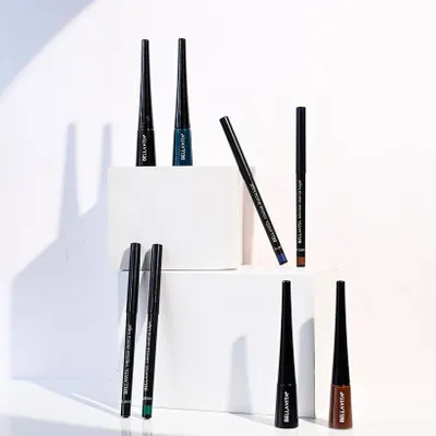 A vibrant and dynamic product shot for Bella Vita eyeliners. The use of white blocks for staging creates a clean, geometric composition, while the arrangement shows off the full range of colors available.