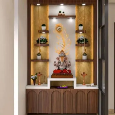 This elegant pooja unit uses a dark wood finish to create a warm and grounded spiritual corner. Multiple shelves with accent lighting are perfect for displaying idols and plants, with a peacock feather adding a touch of grace above the main Ganesha idol.