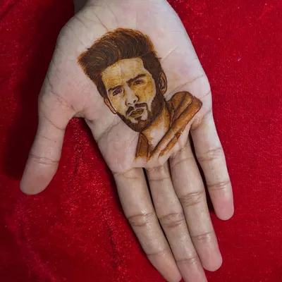 A portrait of Bollywood actor Kartik Aaryan, created entirely with henna. This showcases my ability to capture realistic likenesses, a skill I love bringing to my bridal and custom designs.