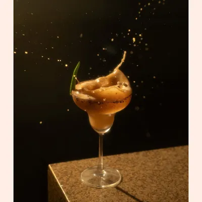 Capturing the magic of a cocktail in motion. This splash shot, with its frozen droplets and dark background, creates a sense of drama and excitement for this beverage.
