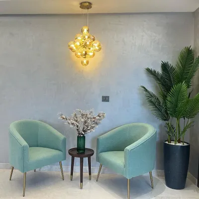 A happy client's space featuring our clustered glass globe pendant. It adds a beautiful, warm touch to their seating area. Seeing our lights in real homes is the best part of my job.