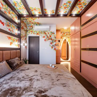This master bedroom from Project Sakura is an immersive, artistic retreat. A hand-painted autumn mural flows across the walls and ceiling, complemented by blush-toned wardrobes and a statement arched mirror.