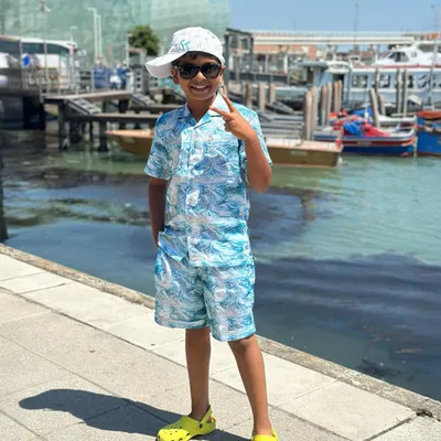 Making waves in our custom summer co-ords. This blue marble-print set, complete with a matching cap, is the perfect outfit for a day by the water.
