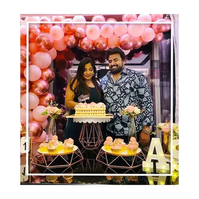 The happy couple, Anusha and Sahith, celebrating their first anniversary. They are pictured here enjoying their cake in front of the rose gold balloon arch and dessert display we created for their special day.