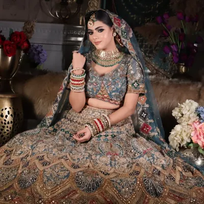 A full-length shot of a regal bridal look, showcasing the intricate lehenga and how the makeup complements the entire outfit. The focus is on creating a cohesive and grand appearance for the wedding day.