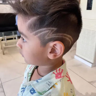 Even the little ones get a rockstar look here. I specialize in fun, creative hair art for kids, like this sharp lightning bolt design, making their haircut experience exciting and stylish.