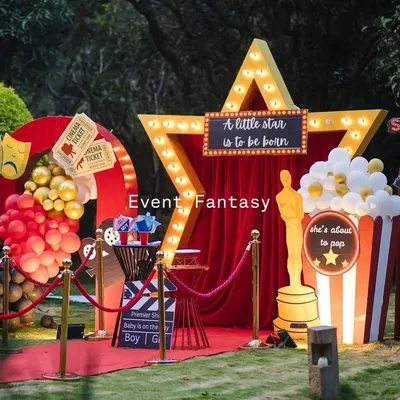 The full 'Lights! Camera! Baby!' setup, ready for the premiere. This movie-themed baby shower features a red carpet, a light-up star, and fun props like a giant popcorn box and film reel, creating an unforgettable experience.