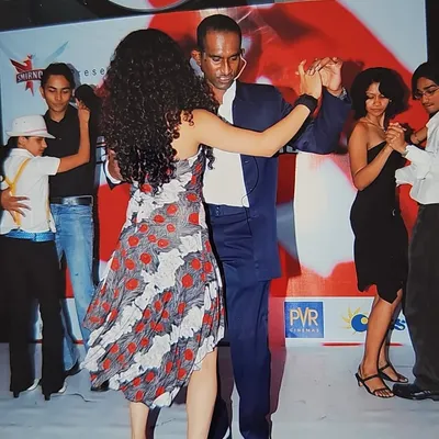A cherished memory from Salsathon, our intra-studio salsa competition. This photo captures our founder dancing, surrounded by the energy of over 800 students and dance lovers.