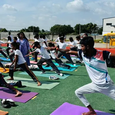Our students practice the warrior pose during an outdoor yoga session. We integrate yoga into our curriculum to enhance flexibility, focus, and inner peace.