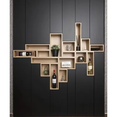 Storage can be a work of art. This custom-built unit features a creative interplay of closed black cabinets and open wooden boxes, creating a visually dynamic display and storage solution for wine, books, and decor.