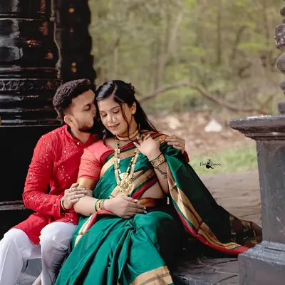 A tender moment captured during a traditional maternity photoshoot. The husband’s gentle kiss and the beautiful green Nauvari saree create a portrait that is rich in both emotion and cultural beauty.
