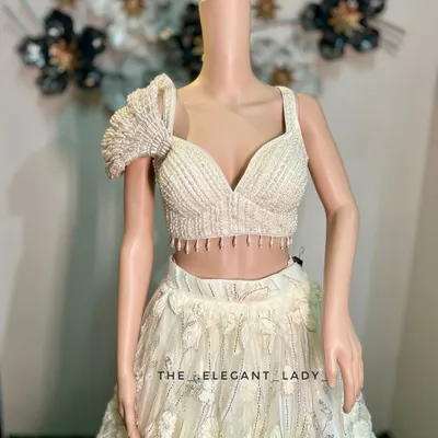 A close-up of the exquisite pearl and beadwork on the blouse of my ivory floral lehenga. The unique ruffled sleeve adds a touch of modern drama to this otherwise ethereal outfit.