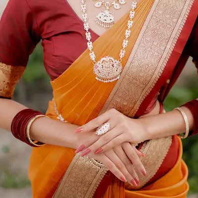 A close-up shot focusing on the hands, jewelry, and waist of a model in a traditional saree. This composition highlights the ring, bangles, and the saree's border, perfect for showcasing a complete ethnic look.