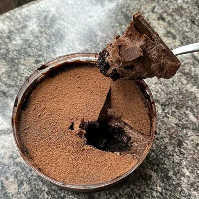 A customer photo of my Dream Cake. It has six different layers and textures of chocolate, from mousse to ganache to cake, all in one tub. It's a chocolate lover's dream.