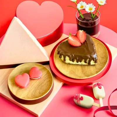 Our Valentine's Day assortment is made for sharing. This beautiful spread includes a heart-shaped cheesecake, heart macarons, and cakesicles, all in a romantic pink and red theme.