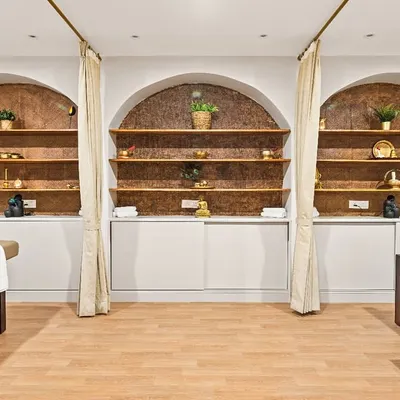 At the Vedic Spa, the treatment areas are designed for ultimate tranquility. I used arched alcoves with warm, textured backdrops and soft, indirect lighting to create individual havens. The simple curtains provide privacy while maintaining a light, airy feel.