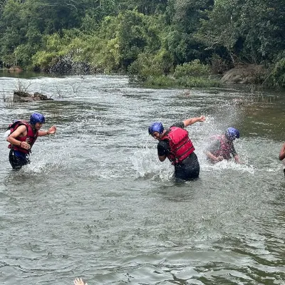 Pure fun and games in the river at Barapole, Coorg. After a thrilling rafting session, participants enjoy a well-deserved splash fight.