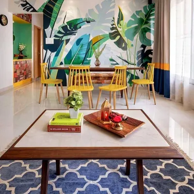 This dining room features a stunning, hand-painted tropical mural that serves as a vibrant backdrop. We offer custom wall art to make your dining and living spaces truly one of a kind.