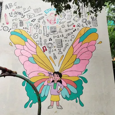 This butterfly girl mural is a favorite in the schools I paint for. It doubles as a fun selfie spot and an educational tool, with the wings filled with doodles about learning and creativity.