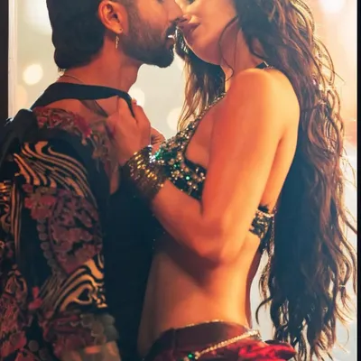 A fiery moment from the 'O Romeo' music video. The hairstyling for Disha Patani here was all about creating voluminous, touchable waves that moved with her and added to the romantic energy of the scene.