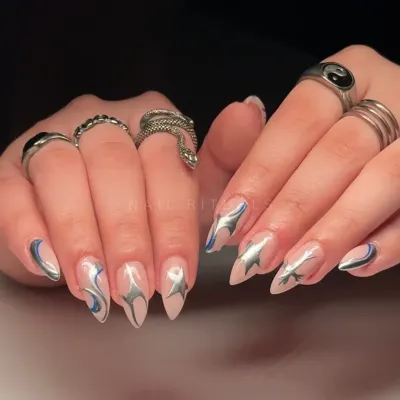 Silver stars and cosmic swirls give this set a celestial energy with every gesture. This edgy design features metallic silver art with a hint of blue on a nude base.