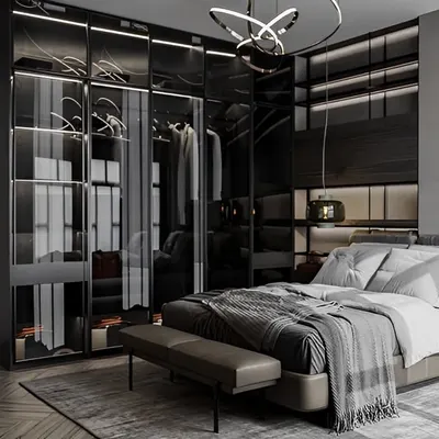 A sophisticated master bedroom featuring a large wardrobe with smoked glass doors and integrated lighting. This design turns clothing storage into a stunning display feature.