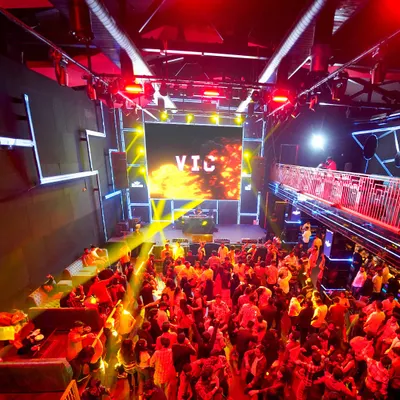 A view from above at a packed corporate party at Ignite Superclub. My custom "VIC" branding on the main LED screen and the vibrant lighting design show how I transform a venue into a high-energy audio-visual spectacle.