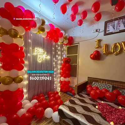 This is a complete romantic room takeover, featuring red and gold balloon columns, a "Better together" neon sign, and a bed decorated with rose petals and "I LOVE YOU" foil balloons.
