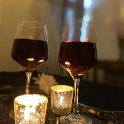 Two glasses of red wine and candles. This is the simple, classic romance that I set up for my guests.