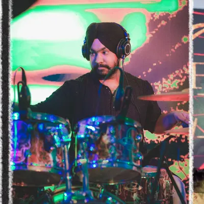 Our drummer, lost in the rhythm. He provides the powerful heartbeat that drives our high-energy performances.