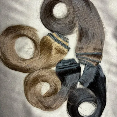 I pride myself on finding the perfect color match for my clients. This image showcases a variety of premium clip-on sets in different natural shades, ready for customization.