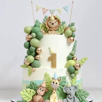 A non-fondant jungle safari cake. All the cute animals, like the lion, giraffe, and elephant, are hand-modelled with fondant, which you'll learn to do in my character class.