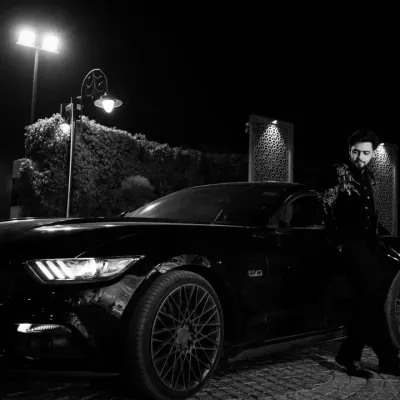 Modern groom, classic style. This black and white shot with a Ford Mustang creates a cool, cinematic feel, perfect for capturing the groom's personality.