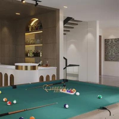 A sophisticated game room featuring a pool table and a stylish custom bar with an arched design and brass accents.