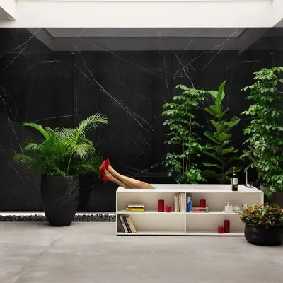 In this 9,000 sq. ft. tile showroom, a pair of crimson stilettos peeks out from a bathtub, a playful scene of opulent indulgence. We designed this space as a canvas where every tile tells a story of style, sophistication, and imagination.